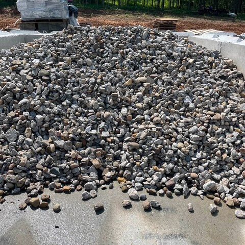 Gravel being spread in garden center for landscaping or construction.